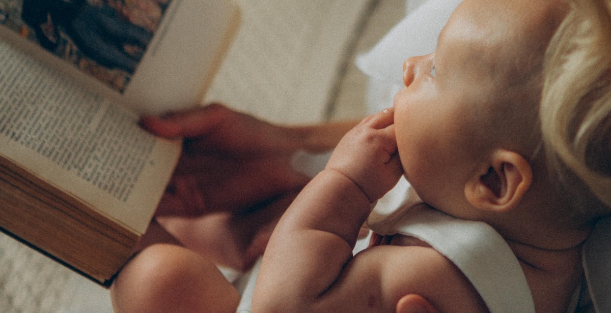 baby reading to book