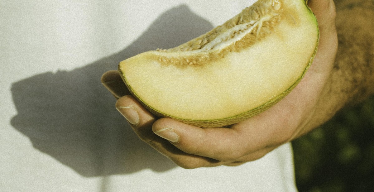 hand holding a ripe fruit