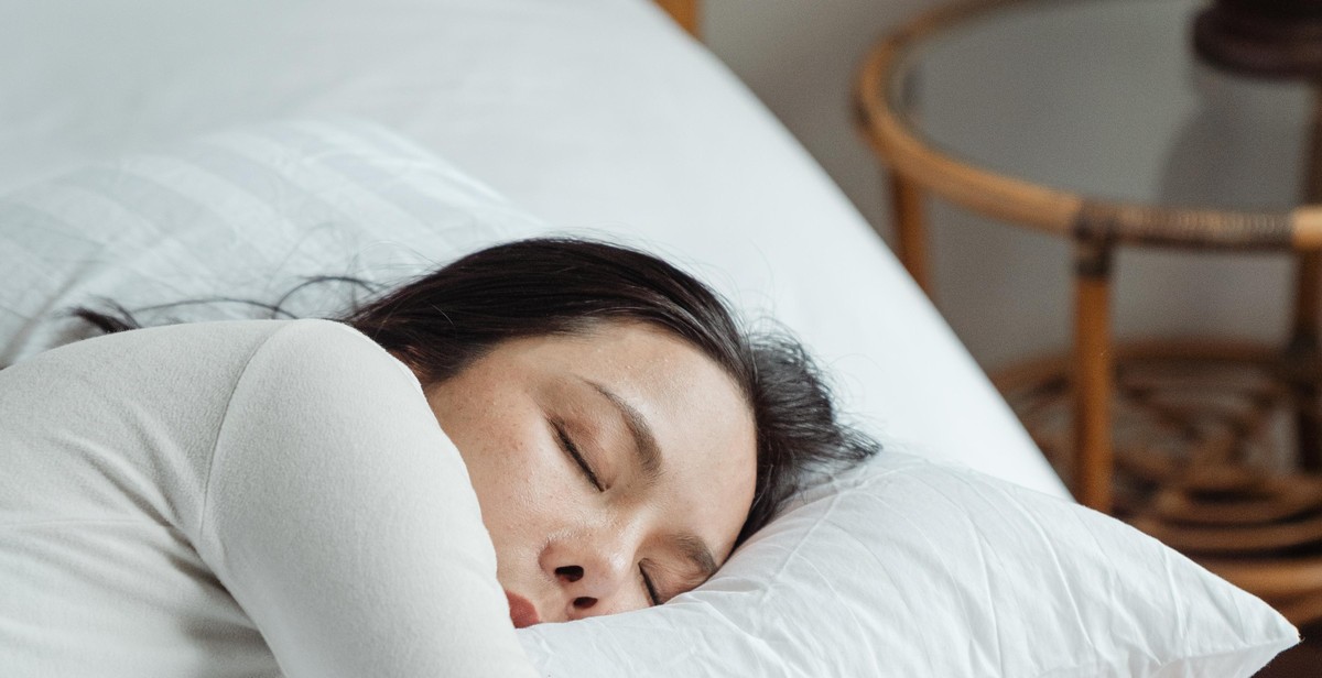 pregnant woman sleeping in a comfortable bed