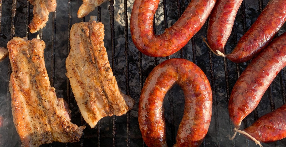 sausages on a charcoal smoker