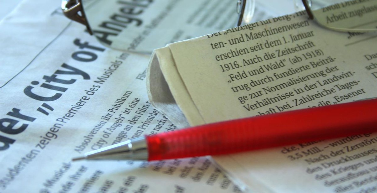newspaper and pen